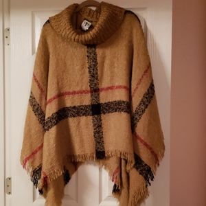 Tan, black, and red poncho.